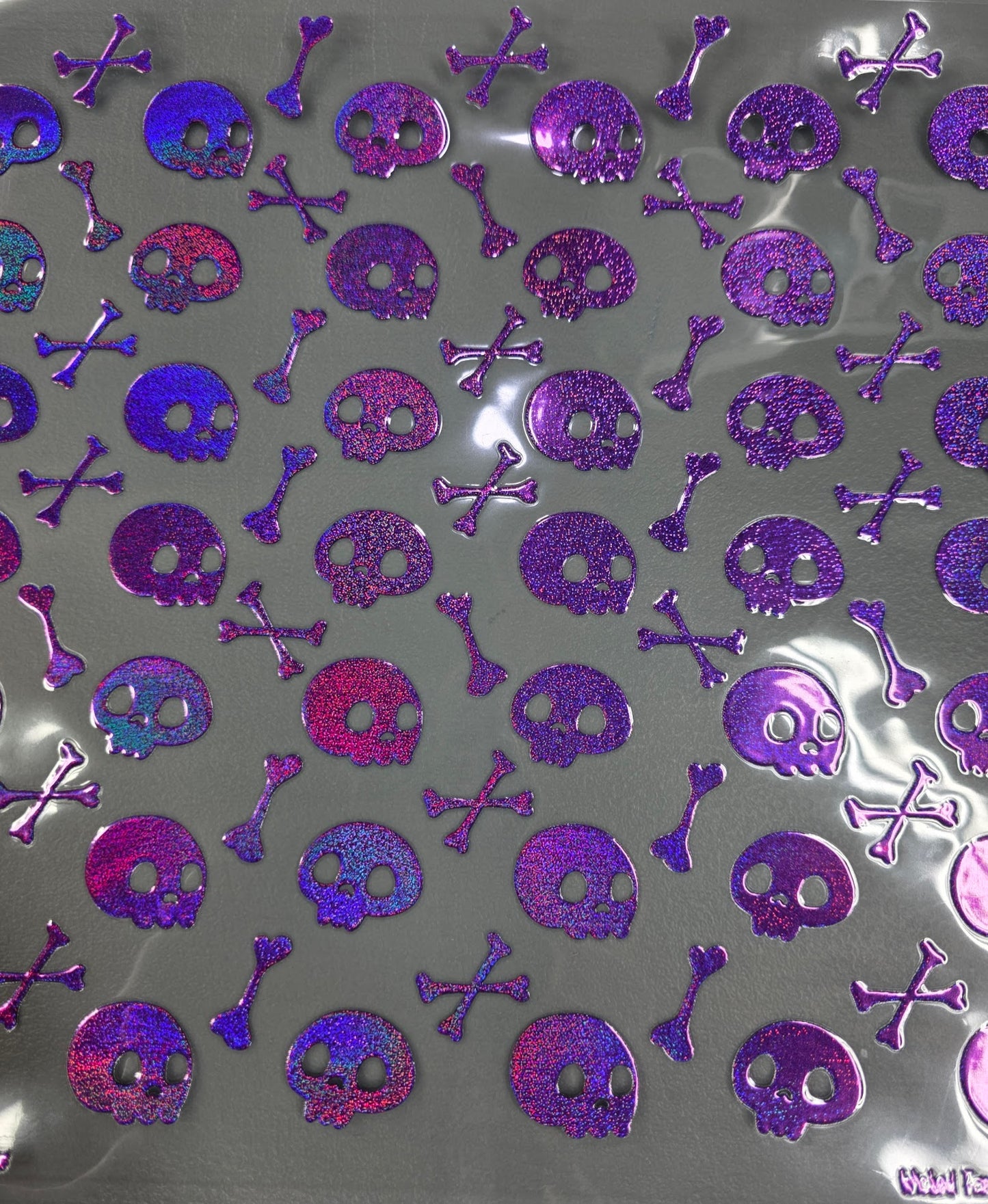 UVDTF Prism Purple Holographic Skulls and Crossbones 11x11"