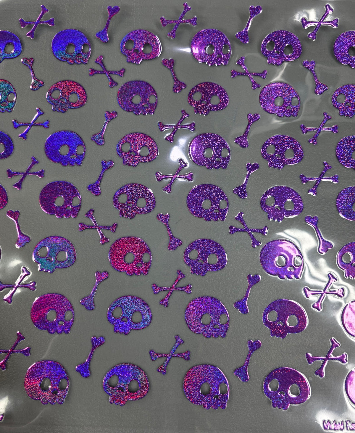 UVDTF Prism Purple Holographic Skulls and Crossbones 11x11"
